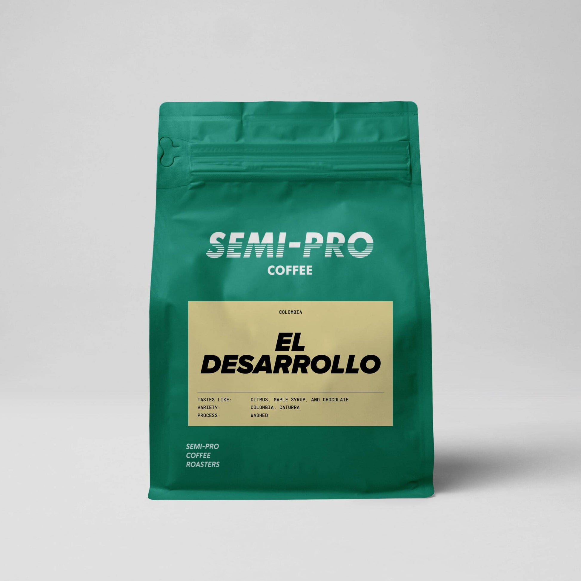 Green Semi-Pro branded coffee bag with yellow label which reads 'El Desarrollo' tastes like citrus, maple syrup and chocolate