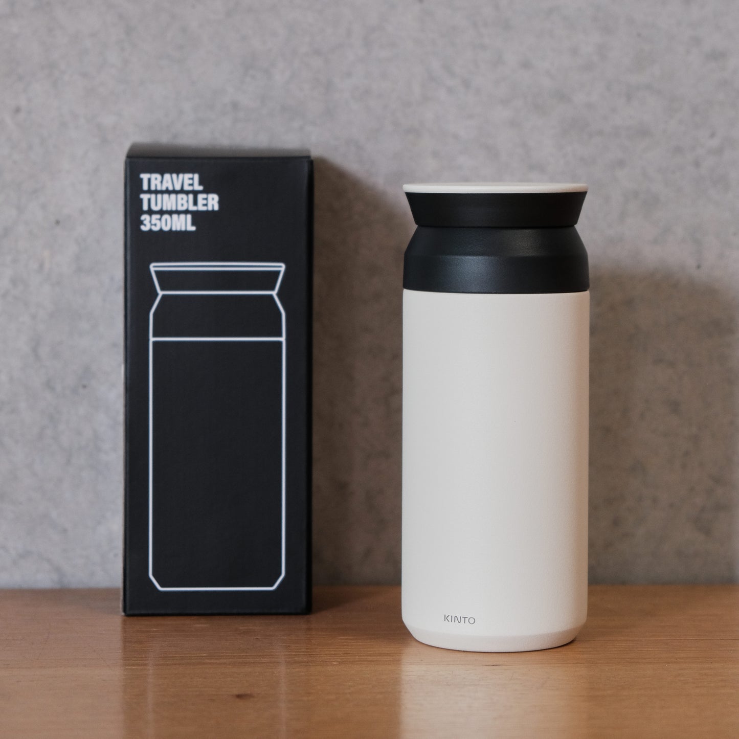 Matte white coloured travel cup with black lid